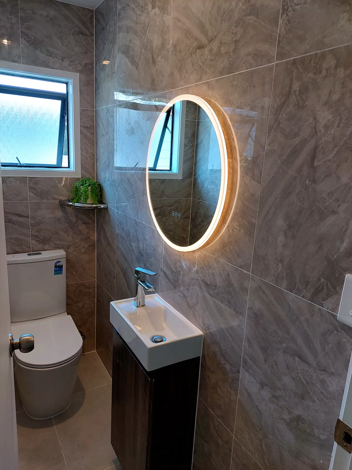 Bathroom renovation in Grey Lynn, Auckland — Round mirror & vanity, by HouseMakeover